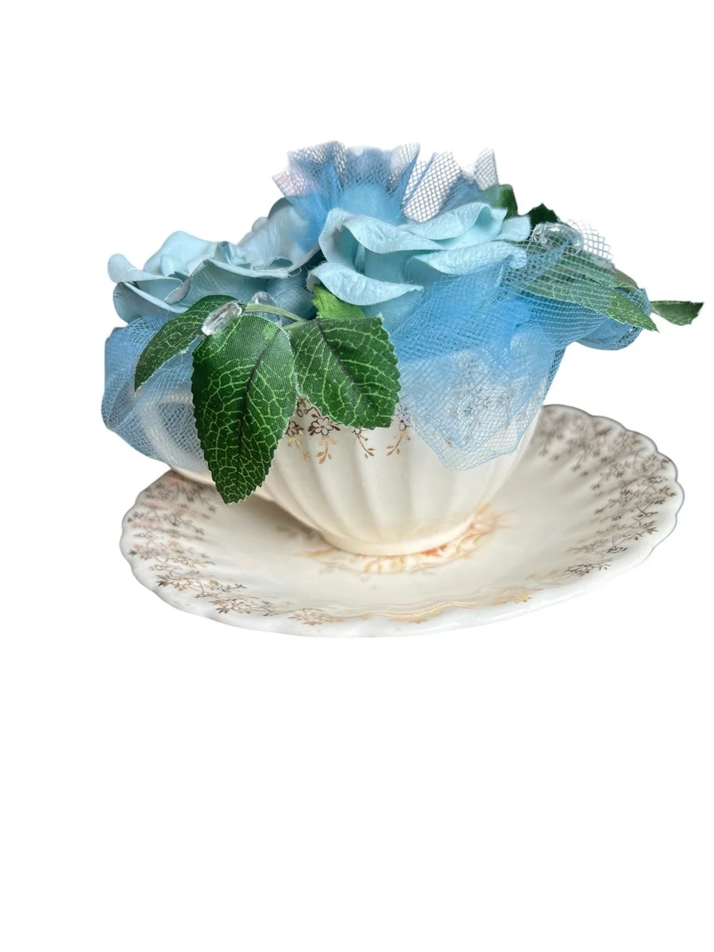 American Limoges vintage Teacup and saucer with blue artificial flowers.